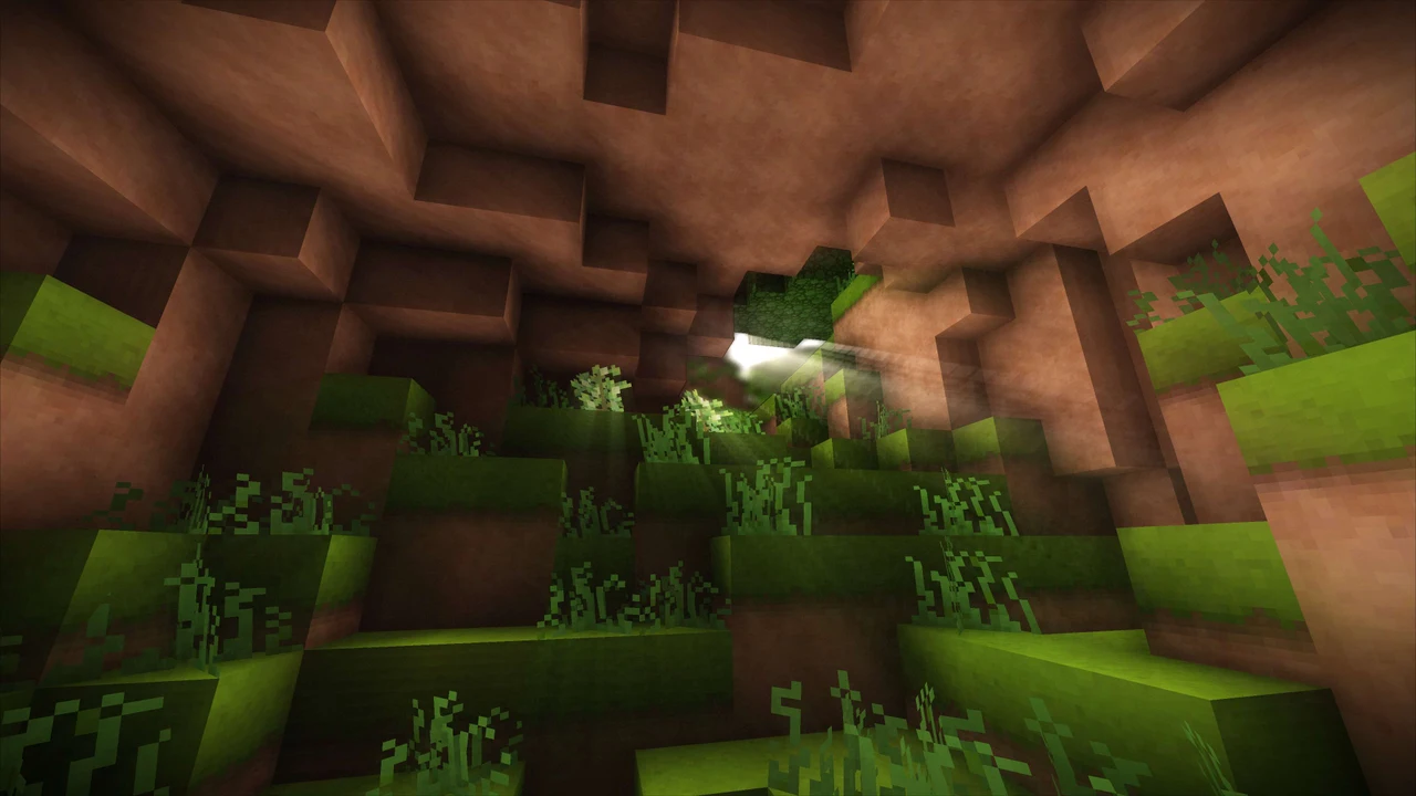 A sunlit, grass-covered voxel cave in Terasology, a game by MovingBlocks